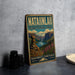 A vintage-style metal sign for Natainlai Territorial Park, featuring a scenic mountain landscape with a waterfall and wildflowers.