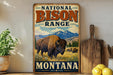 a vintage-style sign for the National Bison Range in Montana, with a bison illustration and the text "Montana" and "Est. 1908" below.