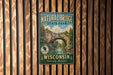 A vintage metal sign for Natural Bridge State Park in Wisconsin, featuring a scenic illustration of the bridge surrounded by trees and water.