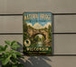 A vintage-style metal sign for Natural Bridge State Park in Wisconsin, featuring a scenic illustration of the bridge surrounded by trees and a river.