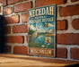 A vintage-style metal sign for the Necedah National Wildlife Refuge in Wisconsin, featuring an illustration of a bird and a lake surrounded by trees.