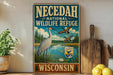 A vintage-style sign for the Necedah National Wildlife Refuge in Wisconsin, featuring an illustration of a bird and a lake surrounded by trees.