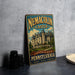 A vintage-style metal sign for the Nemacolin Castle in Pennsylvania, featuring an illustration of the castle and the text "A DESTINATION LIKE NO OTHER PENNSYLVANIA PENNSYLVANIA HISTORY LUXURY MEMORIES".