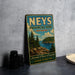 A vintage-style metal sign for Nees Provincial Park, Ontario, featuring a scenic landscape with pine trees, a lake, and mountains.