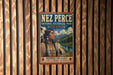 A vintage-style metal sign with the name "NEZ PERCE" and the text "NATIONAL HISTORICAL PARK IDAHO" displayed prominently.