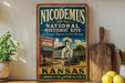 A vintage-style sign for the Nicodemus National Historic Site in Kansas, featuring an illustration of a historic building and a car.