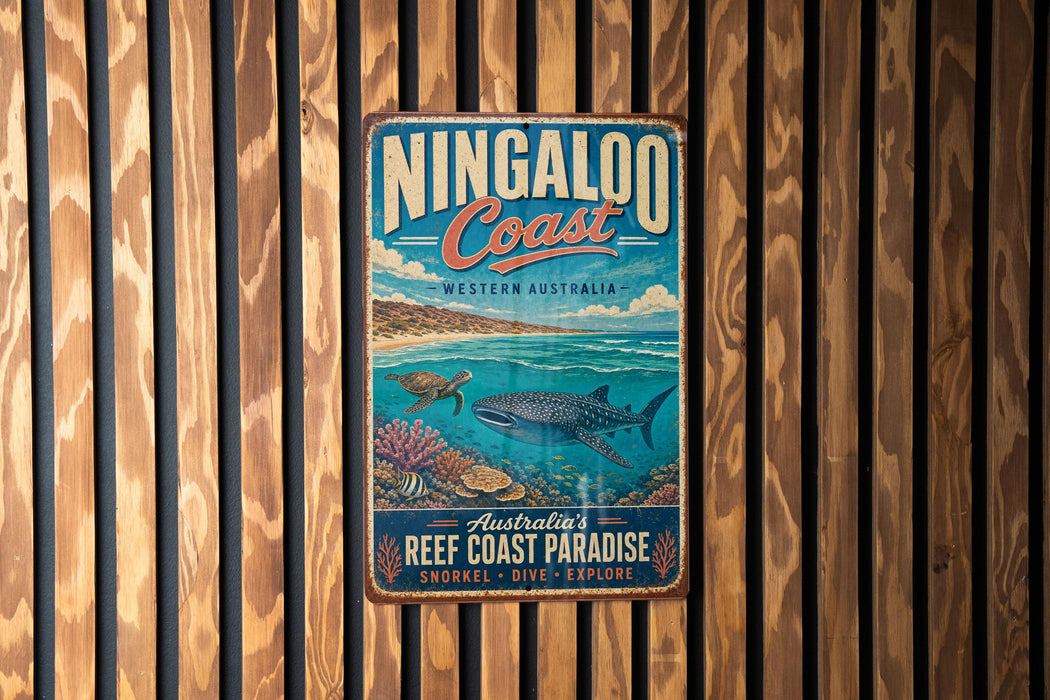 A vintage-style metal sign for the Ningaloo Coast, Western Australia, featuring an illustration of a whale shark, a sea turtle, and coral reefs.