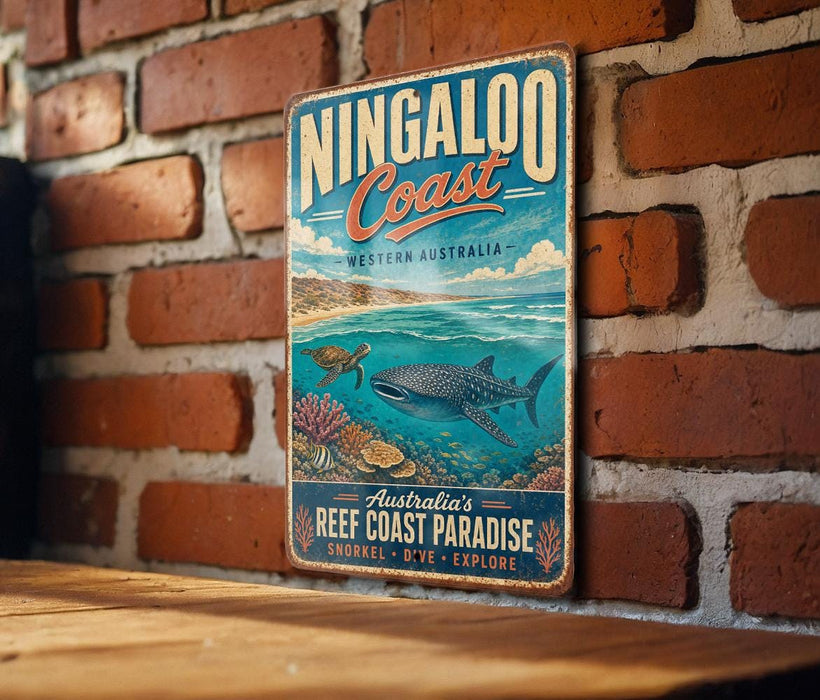 A vintage-style metal sign for the Ningaloo Coast in Western Australia, featuring an illustration of a whale, coral, and a turtle in the ocean.