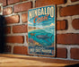 A vintage-style metal sign for the Ningaloo Coast in Western Australia, featuring an illustration of a whale, coral, and a turtle in the ocean.