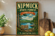 A vintage-style metal sign for the Nipmuck State Forest in Connecticut, featuring a scenic landscape with a lake, mountains, and pine trees.