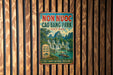 a vintage-style sign for Non Nuc Cao Bang Park, Vietnam, with a waterfall and boats in the background.