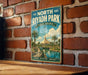 A vintage-style metal sign for North Riyadh Park in Saudi Arabia, featuring a scenic illustration of a park with palm trees and a river.