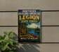 a vintage-style sign for the Northern Highland-American Legion State Forest in Wisconsin, with a scenic illustration of a lake, forest, and canoe.