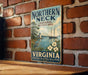 A vintage-style sign for the Northern Neck National Heritage Area in Virginia, featuring a sailboat and a lighthouse, mounted on a brick wall.