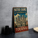 A vintage metal sign advertising Notre-Dame Cathedral in Brussels, Belgium, featuring an illustration of the cathedral and the text "NOTRE-DAME CATHEDRAL TOURNAI BELGIQUE".