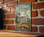 A vintage-style metal sign with the text "NOTTOWAY PLANTATION LOUISIANA" and an illustration of a building, mounted on a brick wall.