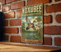A vintage-style metal sign for the Noxubee National Wildlife Refuge in Mississippi, featuring a bird in flight and a serene landscape.