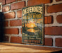 A vintage-style metal sign for the Okefenokee National Wildlife Refuge, featuring an illustration of a bird and a sunset over a body of water.