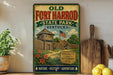 a vintage-style sign for Old Fort Harrod State Park in Kentucky, with a wooden fence and a building depicted on the sign. The sign is displayed on a shelf next to a potted plant and a wooden cutting board, along with some lemons.