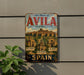 A vintage metal sign advertising the Old Town of Avila, Spain, with the text "Old Town of Avila with its extra-muros churches" and the names of the churches below.