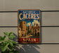 a vintage-style metal sign that reads "Old Town of Cáceres, Spain" with a picture of a town on it.