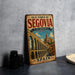 A vintage metal sign for the Old Town of Segovia, Spain, featuring an illustration of the historic aqueduct and the town's architecture.