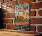 A vintage-style metal sign for the Old Walled City of Shibam, Yemen, featuring a desert landscape with palm trees and a castle-like structure.