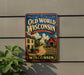 A vintage-style metal sign for "Old Wisconsin" is displayed on a wall, featuring an illustration of a rural scene with a barn, wagon, and other elements characteristic of Wisconsin's history and heritage.