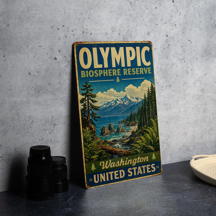 A vintage-style sign for the Olympic Biosphere Reserve in Washington, United States, featuring a scenic landscape with mountains, pine trees, and a body of water.