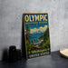 A vintage-style sign for the Olympic Biosphere Reserve in Washington, United States, featuring a scenic landscape with mountains, pine trees, and a body of water.