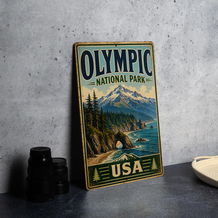 A vintage-style sign for Olympic National Park in the USA, featuring a scenic mountain landscape with pine trees and a body of water.
