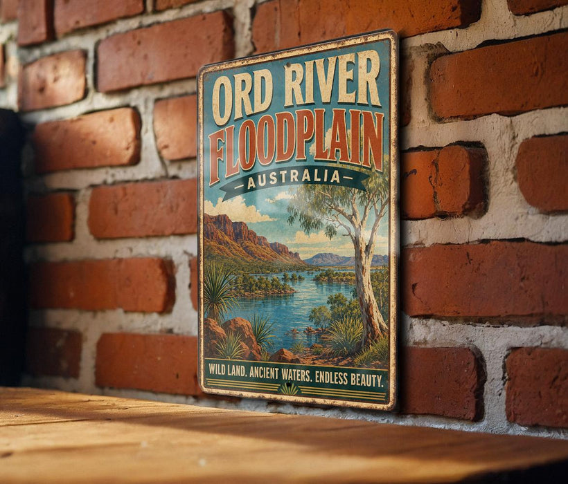 A vintage-style metal sign with the text "ORD RIVER FLOODPLAIN AUSTRALIA" and a scenic illustration of a river surrounded by mountains and vegetation.