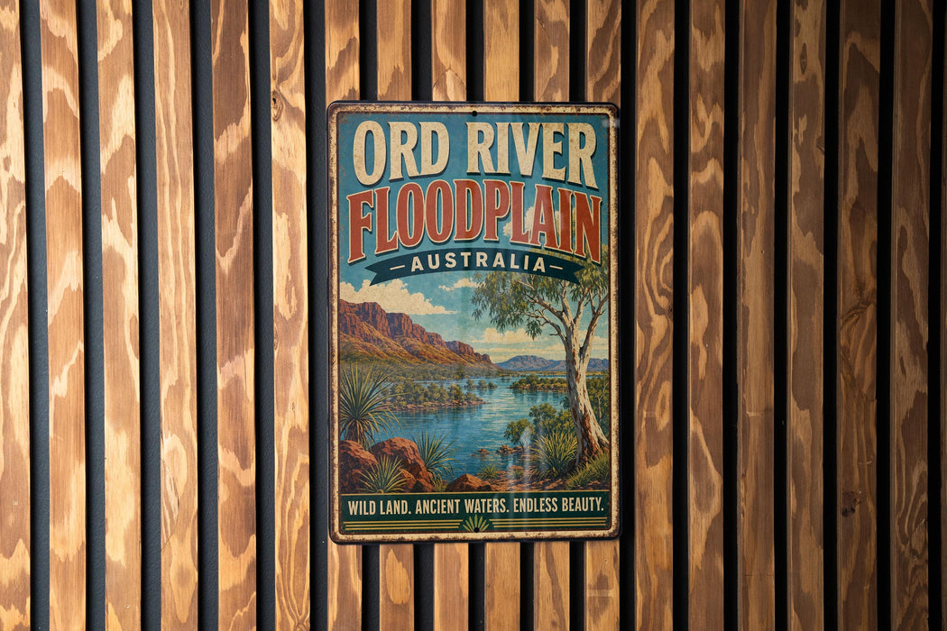 A vintage-style metal sign for the Ord River Floodplain in Australia, featuring a scenic landscape with mountains, water, and vegetation.