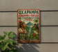 a vintage-style sign with a colorful illustration of a native Peruvian figure, surrounded by lush greenery and a waterfall, promoting the Oxapampa Asháninka-Yanesha Biosphere Reserve in Peru.