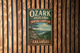 A vintage-style metal sign for Ozark Highlands Heritage Landscape in Arkansas, featuring a scenic landscape with a river and mountains.