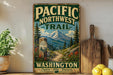 A vintage-style sign for the Pacific Northwest Trail in Washington, featuring a mountain landscape and a trail marker.