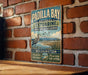 A vintage-style metal sign for Padilla Bay National Estuarine Research Reserve, featuring a bird and a scenic landscape.