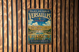 A vintage metal sign for the Palace and Park of Versailles in France, featuring an illustration of the palace and its gardens.