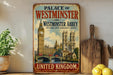 A vintage-style metal sign for the Palace of Westminster and Westminster Abbey in London, England, featuring the iconic Big Ben and Westminster Abbey.