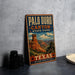A vintage-style metal sign for Palo Duro Canyon State Park in Texas, featuring a desert landscape with a prominent rock formation.