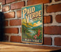 A vintage-style metal sign with the text "PALO VERDE" and "COSTA RICA" is displayed on a brick wall.