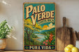 A vintage-style poster of the city of Pura Vida, Costa Rica, featuring a scenic landscape with a river, mountains, and tropical vegetation.