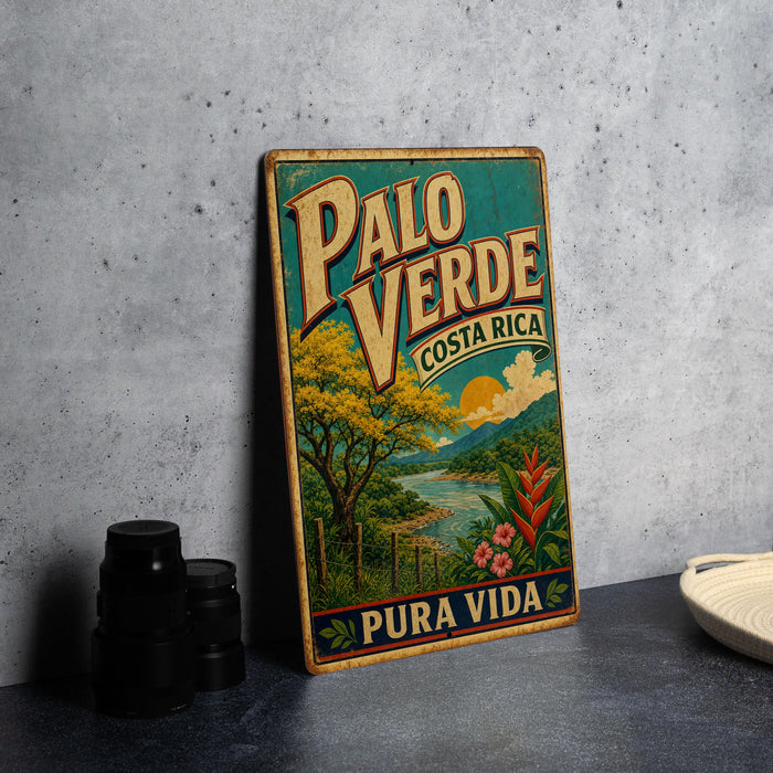 A vintage-style metal sign with the text "PALO VERDE" and "COSTA RICA" is displayed on a gray concrete surface, along with a small white bowl and a stack of black camera lenses.