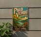 A vintage-style sign for "Palo Verde" coffee from Costa Rica, featuring a tropical landscape with palm trees, flowers, and a river.
