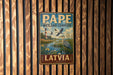A vintage metal sign with the text "PAPE WETLAND COMPLEX LATVIA" is displayed on a wooden wall.