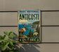 A vintage-style metal sign for the Park National of Anticosti, featuring a reindeer and a scenic coastal landscape.