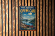 A vintage-style metal sign for the Parc National de OemICAN in Quebec, featuring a scenic landscape with a canoe on a lake.