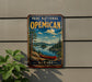 A vintage-style metal sign for the "Parc National Opecan" in Quebec, featuring a scenic landscape with a canoe on a lake.