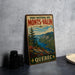 A vintage metal sign for the PARC NATIONAL DES MONTS-VALIN, a park in Quebec, Canada, featuring a scenic landscape with mountains, forests, and a lake.