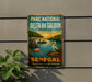 A vintage-style metal sign with a colorful illustration of a tropical scene, including a flamingo, palm trees, and a body of water, mounted on a wall.